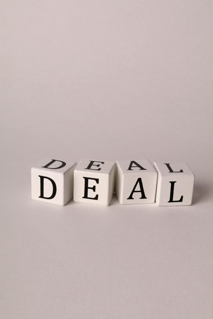 Close-up of white cubes with black letters forming the word 'Deal', ideal for business negotiations or agreements theme.